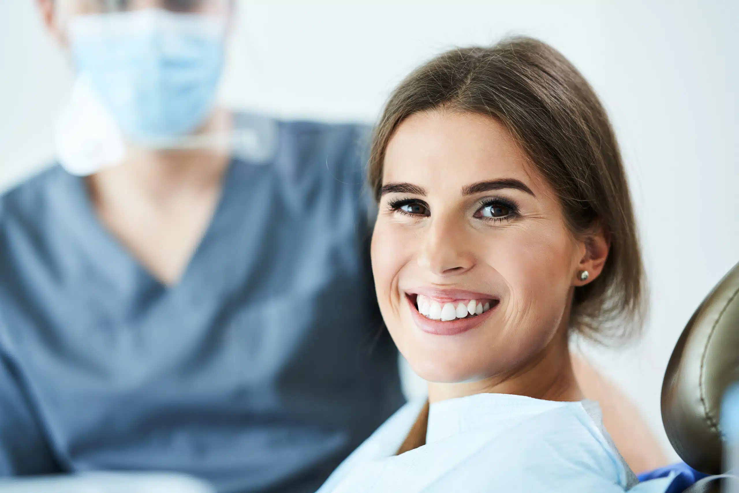 Male dentist and woman in dental clinic