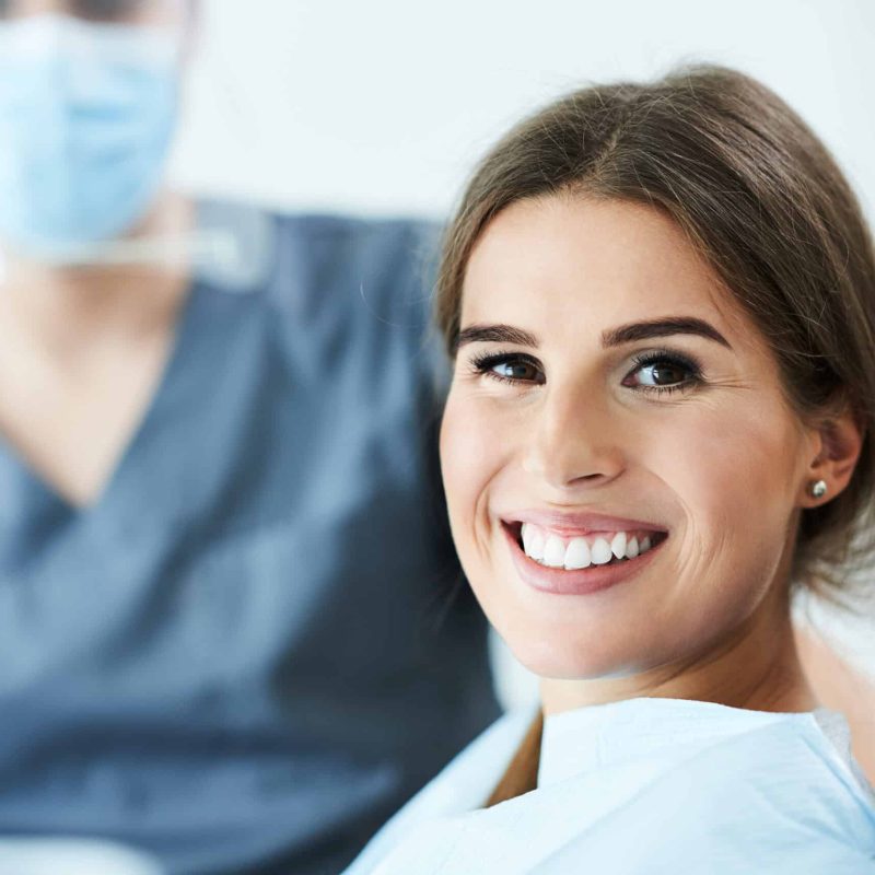 Male dentist and woman in dental clinic